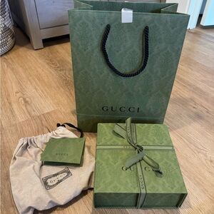 Gucci shoppingg bag, box, ribbon, dust bag and receipt holder.